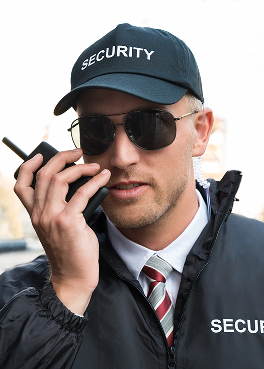 male-unamed-security-guard-talking-on-walkie-talkie