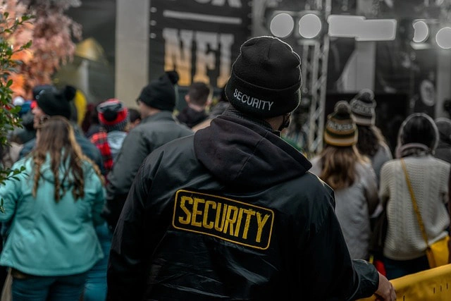 security-guy-behind-the-crowd